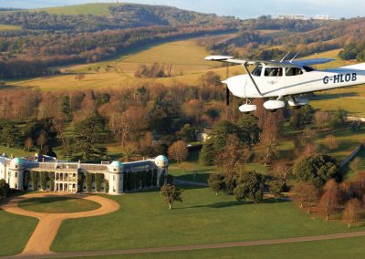 Photo of a plane flying over Goodwood House 