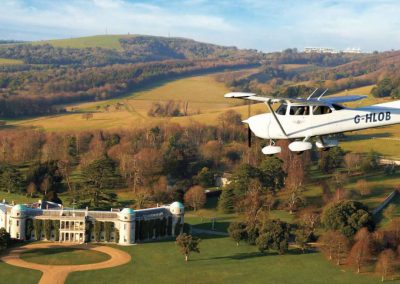 Photo of a plane flying over Goodwood House